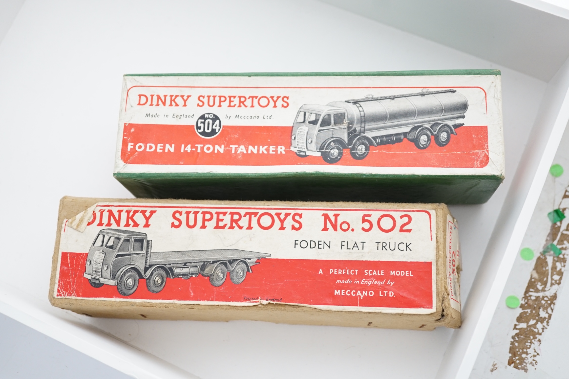 Two boxed Dinky Supertoys first type Fodens; a 14-ton tanker (504), with dark blue cab and chassis, and pale blue tank and wheels and a Flat Truck (502), in green with silver flash, in correct colour-marked box